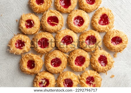 Kue janda genit atau janda bolong, or known as thumbprint cookies. A very common snacks for holiday season including eid'l fitr or Lebaran. Made of flour and cheese for cookies, and sweet jams on top.