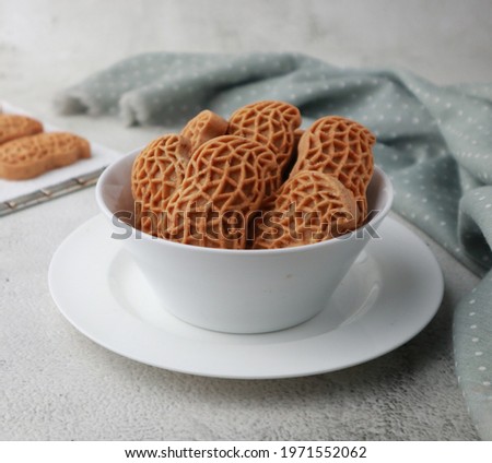 Kue kacang (Bahasa) or peanut butter cookies. Made from peanut jam, flour, egg and sugar. It haped like a peanut skin. Selective focus. 
