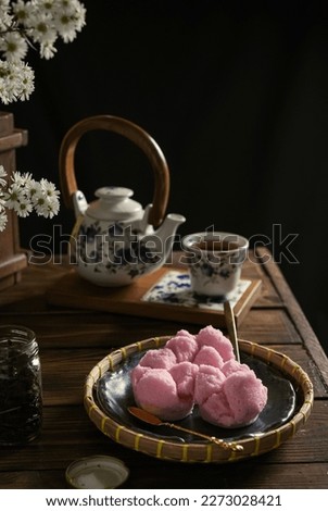 Kue mangkok, kue apem, pink cup cake on the wooden table