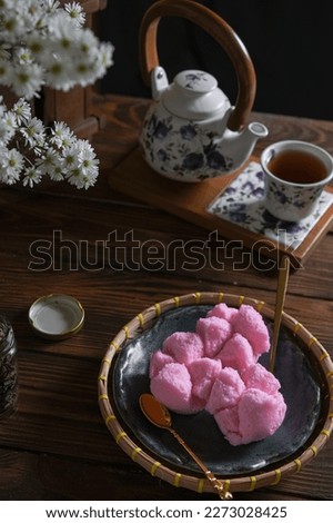 Kue mangkok, kue apem, pink cup cake on the wooden table