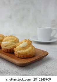 Kue Sus Durian Or Soes Vla Durian Or Cream Puff With Durian Custard Filling. On Wooden Plate. Selective Focus, Blurry Background, Bokeh Concept. 
