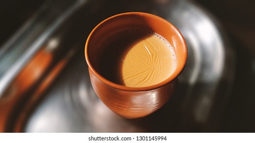 A kulhar or kulhad cup (traditional handle-less clay cup) from North India filled with hot Indian tea.