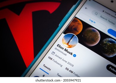 Kumamoto, JAPAN - Aug 26 2021 : Conceptual closeup Elon Musk twitter account on iPhone on Tesla logo.