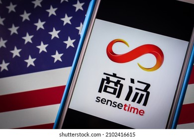 Kumamoto, JAPAN - Dec 14 2021 : The Logo Of SenseTime, A Hong Kong Based Leading Artificial Intelligence Software Company, On IPhone On US Flag In Dark Mood.