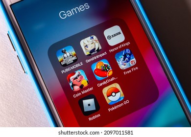 Kumamoto, JAPAN - Dec 22 2021 : 8 Popular mobile games (PUBG, Genshin Impact, Honor of Kings, Coin Master, Candy Crush Saga Online, Garena Free Fire, Roblox and Pokemon Go) on iPhone.