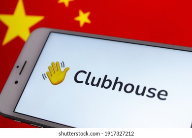 Kumamoto, JAPAN - Feb 15 2021 : Concept image Clubhouse app on iPhone screen with Chinese flag background. Clubhouse app reportedly banned in China in Feb 2021