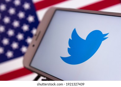 Kumamoto, Japan - Feb 16 2021 : Concept image Twitter logo on iPhone with US flag. Twitter is an American microblogging and SNS on which users post and interact with messages known as "tweets".