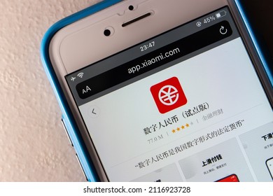 Kumamoto, JAPAN - Jan 20 2022 : Closeup of Digital Yuan app e-CNY in Xiaomi’s App Store in iPhone on the table. Digital yuan is a form of central bank digital currency, CBDC