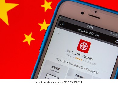 Kumamoto, JAPAN - Jan 20 2022 : Closeup of Digital Yuan app e-CNY in Xiaomi’s App Store in iPhone on Chinese flag. Digital yuan is a form of central bank digital currency, CBDC