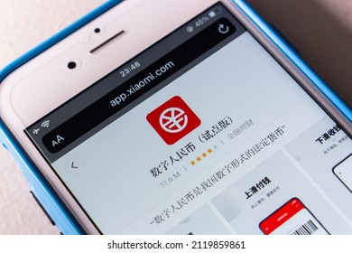 Kumamoto, JAPAN - Jan 20 2022 : Closeup of Digital Yuan app e-CNY in Xiaomi’s App Store in iPhone on the table. Digital yuan is a form of central bank digital currency, CBDC