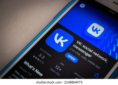 Kumamoto, JAPAN - Mar 23 2022 : The closeup logo of VK app (VKontakte), a Russian online social media and SNS based in Saint Petersburg, in App Store on an iPhone in the dark mood.