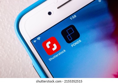 Kumamoto, JAPAN - May 11 2022 : Conceptual image of Shutterstock and POND5 icons on an iPhone home screen. Shutterstock announced that acquisition of Pond5 in May 2022