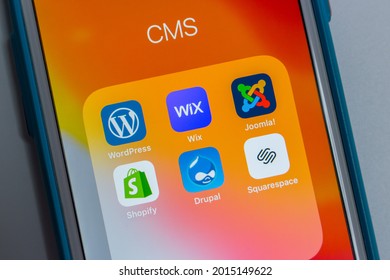 Kumamoto, Japan - May 7 2020 : Popular CMS (Content management system) services, WordPress, Wix, Joomla!, Shopify, Drupal and Squarespace, on orange background on iPhone