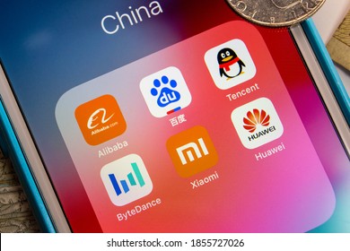 Kumamoto / JAPAN - Oct 2 2020 : China's Tech Giants (The Big Six - Alibaba, Baidu, Tencent, ByteDance, Xiaomi And Huawei) On IPhone With Random Money (coins And Bills).