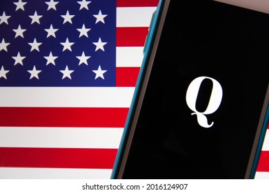 Kumamoto, JAPAN - Oct 20 2020 : Qanon Logo On IPhone With US Flag Background. Qanon Is A Far-right Conspiracy Group