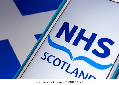 Kumamoto, JAPAN - Sep 6 2021 : Closeup Logo Of NHS Scotland, The Publicly Funded Healthcare System In Scotland, On IPhone On Scottish Flag. It Is The One If The National Health Services In UK.