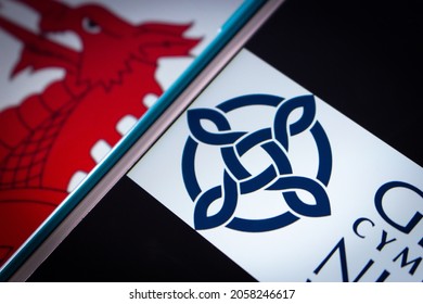 Kumamoto, JAPAN - Sep 6 2021 : Closeup Logo Of NHS Wales (Welsh: GIG Cymru), The Publicly Funded Healthcare System In Wales, On IPhone On Welsh Flag. It’s The One Of The National Health Services In UK