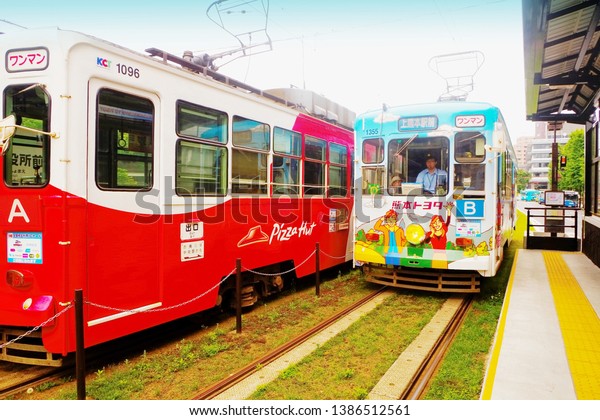 Kumamoto ,Kyushu,Japan - May 10th,2015 : Kumamoto\
city tram (streetcar ,trolley) is public transportation getting\
around inner city to famous spot such as Kumamoto Castle ,Suizenji\
Japanese Garden