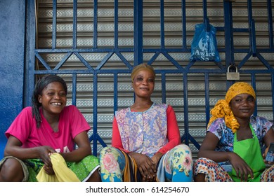 KUMASI, GHANA - JAN 15, 2017: Unidentified Ghanaian women in colored clothes sit at the Kumasi market. Ghana people suffer of poverty due to the bad economy.
