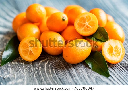 Kumquat or cumquat on wooden table