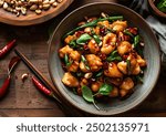 Kung Pao Chicken served in a bowl, featuring a vibrant mix of diced chicken, vegetables, and peanuts, captured from an angle view, professional food photography.