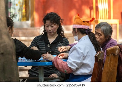 KUNMING, CHINA - APR 13 :  Uidentifield people play Mahjong (Chinese characters) at The Golden Temple Park, is a Taoist bronze-tiled temple in the country located on the Mingfeng Mount on Apr 13, 2009