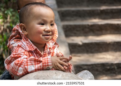 KUNMING, CHINA - APR 13 :  Unidentified kid smile for take a photo at The Golden Temple Park, is a Taoist bronze-tiled temple in the country located on the Mingfeng Mountains on Apr 13, 2009