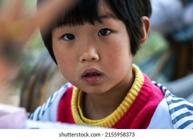 KUNMING, CHINA - APR 13 :  Unidentified Kid take a photo at The Golden Temple Park, is a Taoist bronze-tiled temple in the country located on the Mingfeng Mountains on Apr 13, 2009