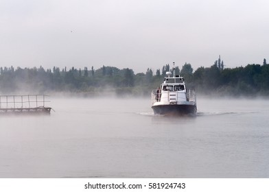 Kurchatov, Russia - JUNE 23, 2016: Reporters sail on a pleasure boat on the reservoir of Kursk NPP. Foggy morning.