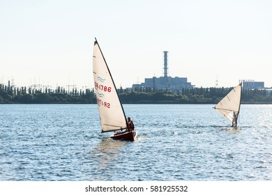 KURCHATOW, RUSSIA - JUNE 23, 2016: Windsurfers are trained on a large lake. Evening shot.
