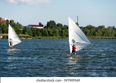KURCHATOW, RUSSIA - JUNE 23, 2016: Windsurfers are trained on a large lake. Evening shot.