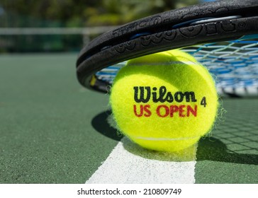 KURUMBA, MALDIVES - JUNE 21 , 2014: Photo of a brand Wilson tennis balls on clay court.  Wilson -  American company of sporting goods. Wilson tennis balls are  official balls of  Davis Cup, Fed Cup.