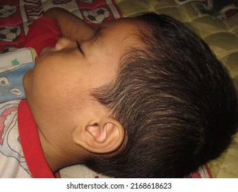 Kutacane, Indonesia, 17 June 2022: Toddler Sleeping In Bed. Asian Toddler                               