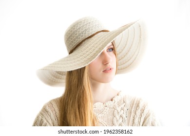 Kuusalu Estonia - April 24 2021: High Key Studio Portrait Of A Caucasian Type Young Woman. Model Has Long Blonde Hair, She Wears Summer Hat And Handknitted Beige Blouse. White Background.