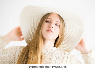 Kuusalu Estonia - April 24 2021: High Key Studio Portrait Of A Caucasian Type Young Woman. Model Has Long Blonde Hair, She Wears Summer Hat And Handknitted Beige Blouse. White Background.