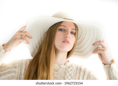 Kuusalu Estonia - April 24 2021: High Key Studio Portrait Of A Caucasian Type Young Woman. Model Has Long Blonde Hair, She Wears Summer Hat And Handknitted Beige Blouse