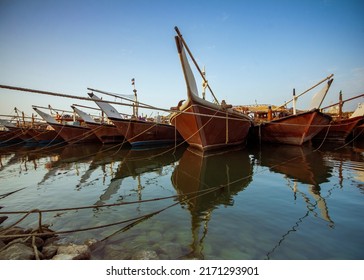 Kuwait fish port with old wood fishing boat and reflection  - Shutterstock ID 2171293901