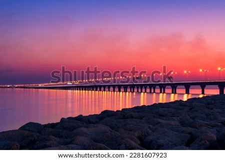 Kuwait Sheikh Jaber Al-Ahmad Al-Sabah Causeway during the evening after sun set. Kuwait Sea Bridge at the evening. 
