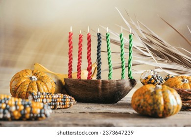 Kwanzaa, african holiday Kwanzaa with decoration of seven candles in red, black and green colors, vegetable harvest, corn. Greeting card banner. Happy Kwanzaa - Powered by Shutterstock