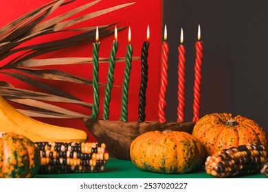 Kwanzaa, african holiday Kwanzaa with decoration of seven candles in red, black and green colors, vegetable harvest, corn. Greeting card banner. Happy Kwanzaa - Powered by Shutterstock