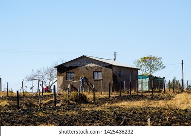 KwaZulu Natal, South Africa - August 20, 2013: Man Working Building His House Covering The Wall With Mud To Isolate It From Warm And Cold. African Poor People.