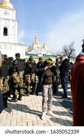 Kyiv, Ukraine 03/08/2019: Woman With Flowers On Her Head Standing Near Soldiers At The Women's March 2019