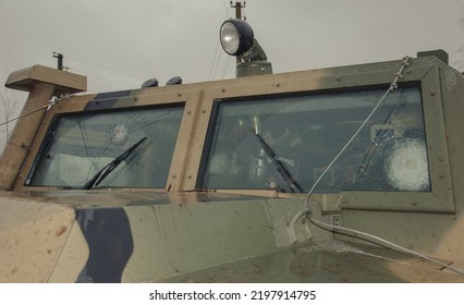 Kyiv, Ukraine – 09 05 2022: The Armored Glass Of A Military Car With Bullet Marks