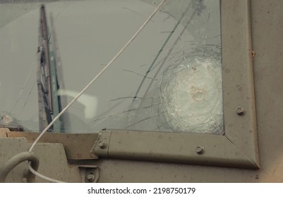 Kyiv, Ukraine – 09 05 2022: The Armored Glass Of A Military Car With Bullet Marks