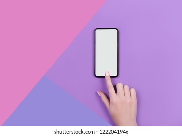 Kyiv Ukraine 2018 10 19. Top view of a woman hand using smart phone on lilac background.