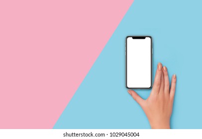 Kyiv, Ukraine, 2018-02-19. Girl Holding  IPhone X  On Pink And Blue Background 