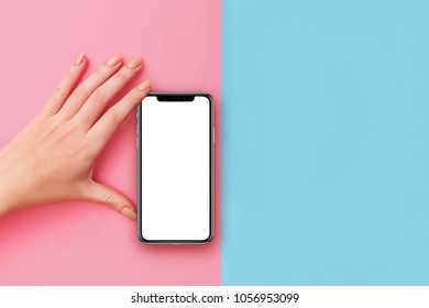 Kyiv, Ukraine, 2018-02-19. Girl Holding  IPhone X  On Pink  Background Clipping Path Inside