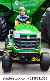 Kyiv, Ukraine - 6 June 2018: John Deere Lawn Mower With Child