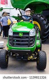 Kyiv, Ukraine - 6 June 2018: John Deere Lawn Mower With Child