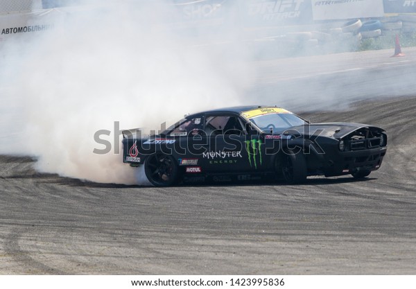Kyiv, Ukraine - 8th of June, 2019: Car\
drifting, Blurred of image diffusion race drift car with lots of\
smoke from burning tires on speed\
track